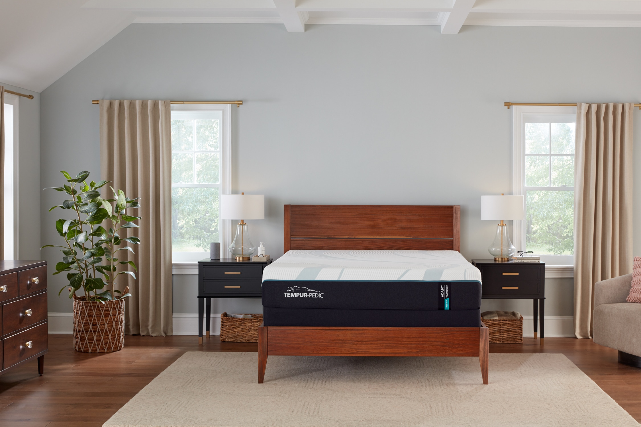 Tempur-Pedic mattress on wooden bed frame in sunlit bedroom setting